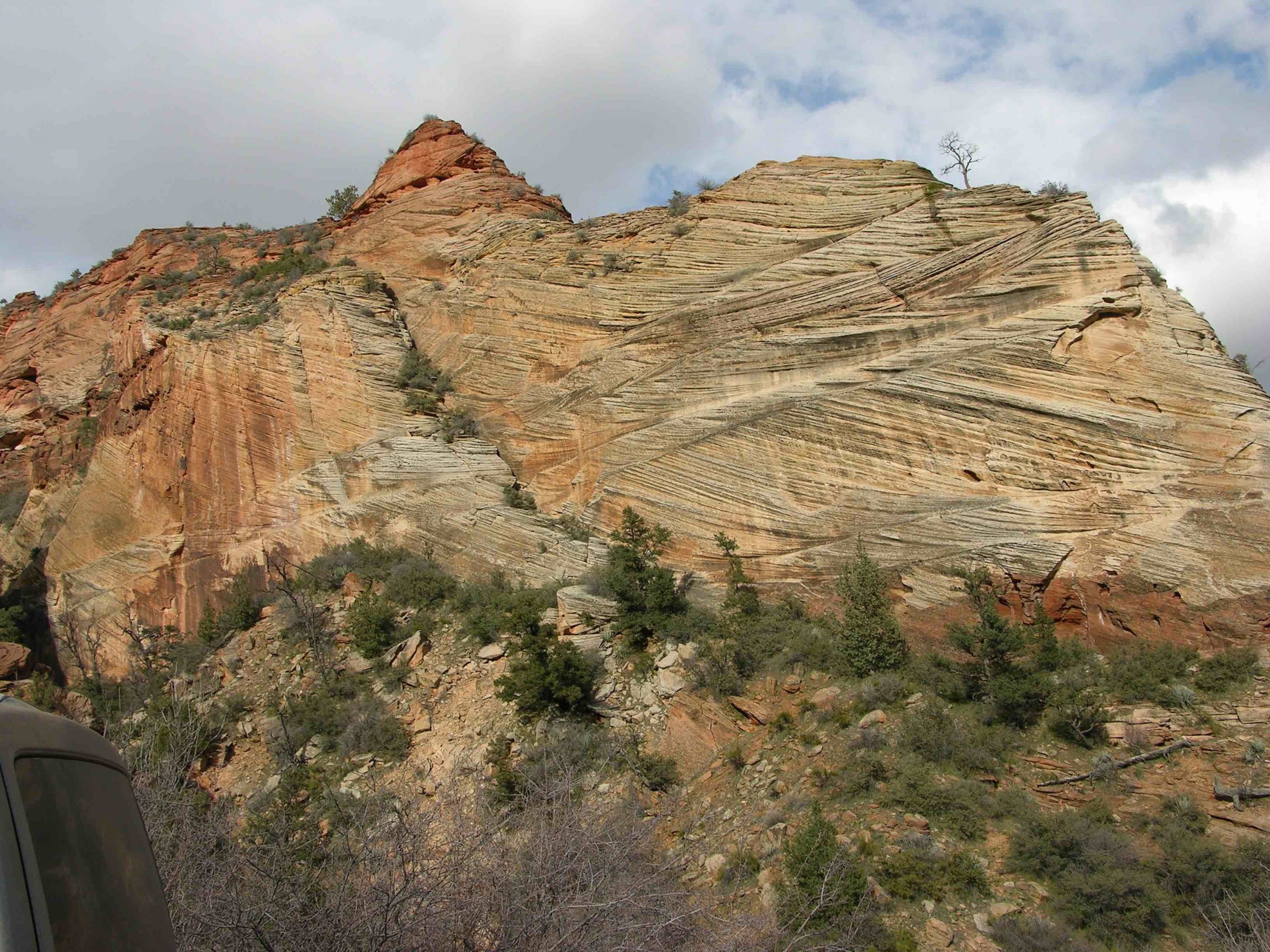 This image shows an example of cross-bedding, which looks like layers of sedimentary rocks dipping in different directions.