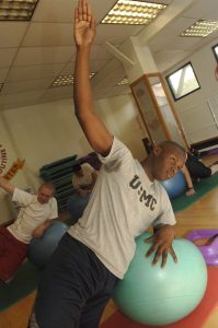 Cpl. Anthony Von Rogers, administration clerk, Consolidated Personnel Administration Center, reaches for the sky during one of the exercises in the abdominals class.